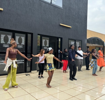 people performing a dance in front of building